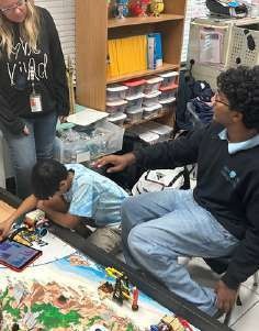 Short Circuit members mentoring a younger FIRST LEGO League student.