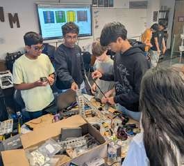 Students building robots at the OSS summer robotics camp.