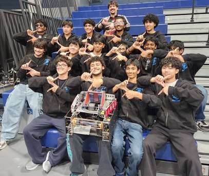 Short Circuit’s 2025–26 team posing together with their robot.